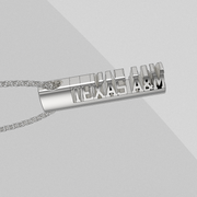 Oval silver TEXAS A&M bar pendant shown on a light gray background